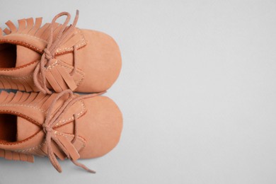 Cute baby shoes on grey background, flat lay. Space for text