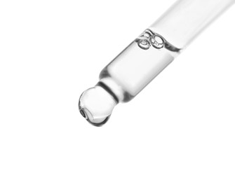 Photo of Dripping clear facial serum from pipette on white background, closeup