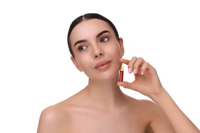 Photo of Beautiful young woman holding skincare ampoule on white background