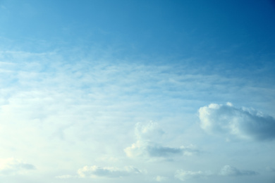 Beautiful light blue sky with fluffy clouds