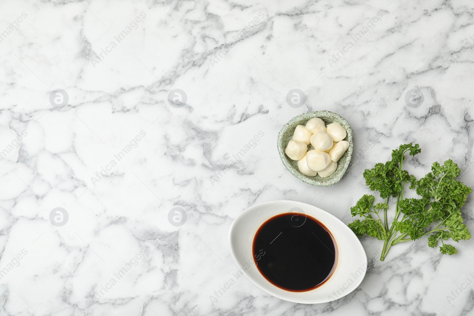 Photo of Flat lay composition with balsamic vinegar in gravy boat and space for text on marble background