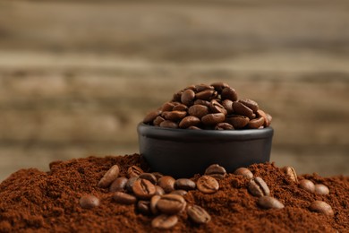 Photo of Bowl with roasted beans on ground coffee, closeup