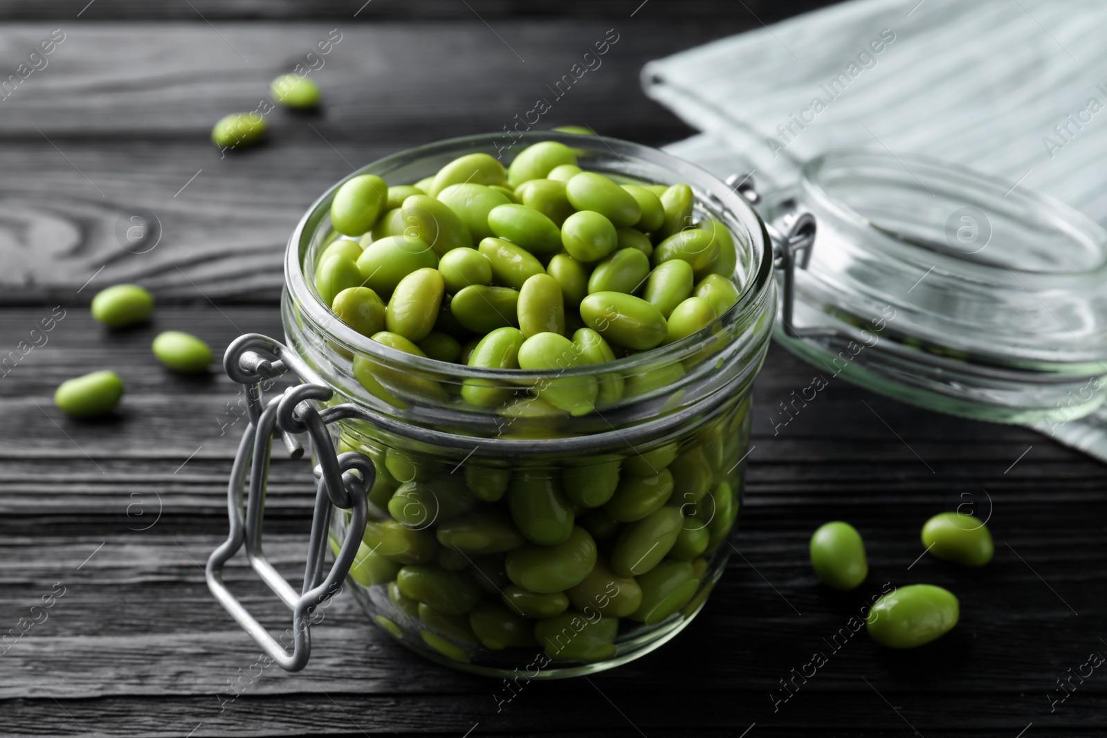 Photo of Jar of edamame beans on black wooden table