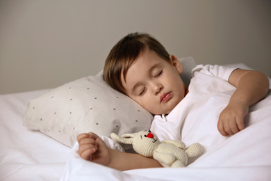 Cute little baby sleeping with toy at home. Bedtime
