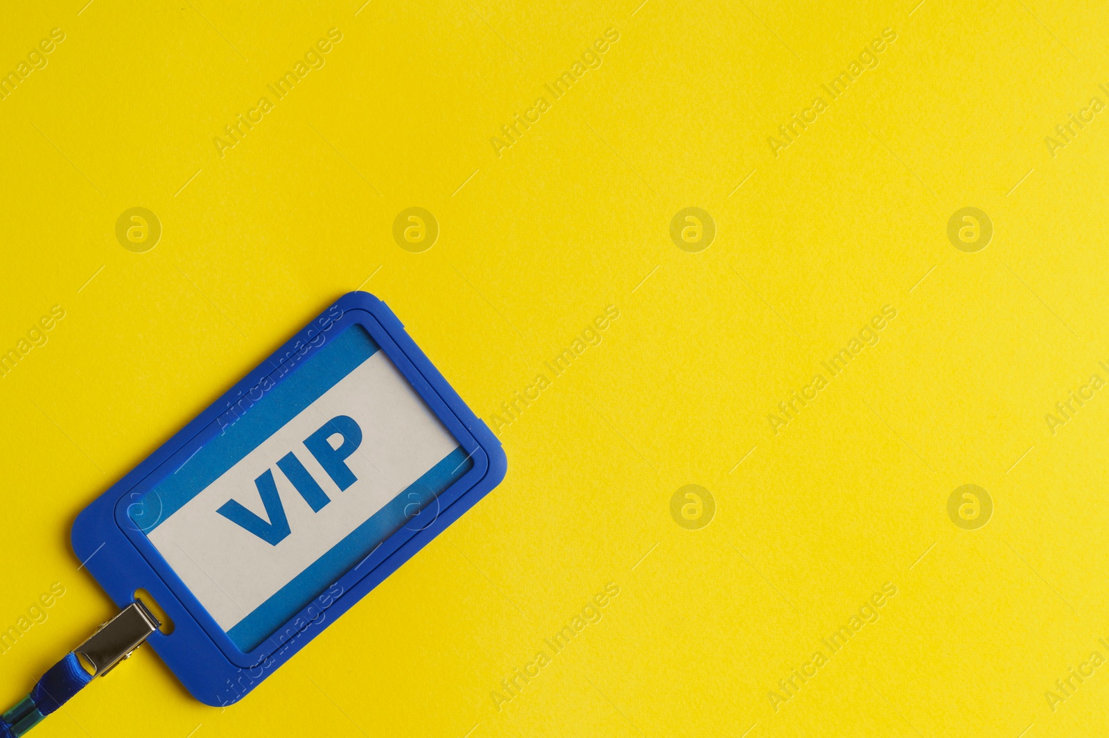 Photo of Vip badge on yellow background, top view. Space for text