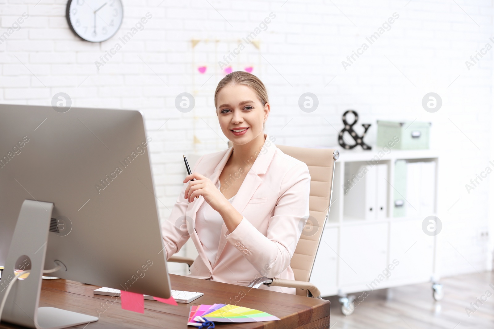 Photo of Female designer working at desk in office