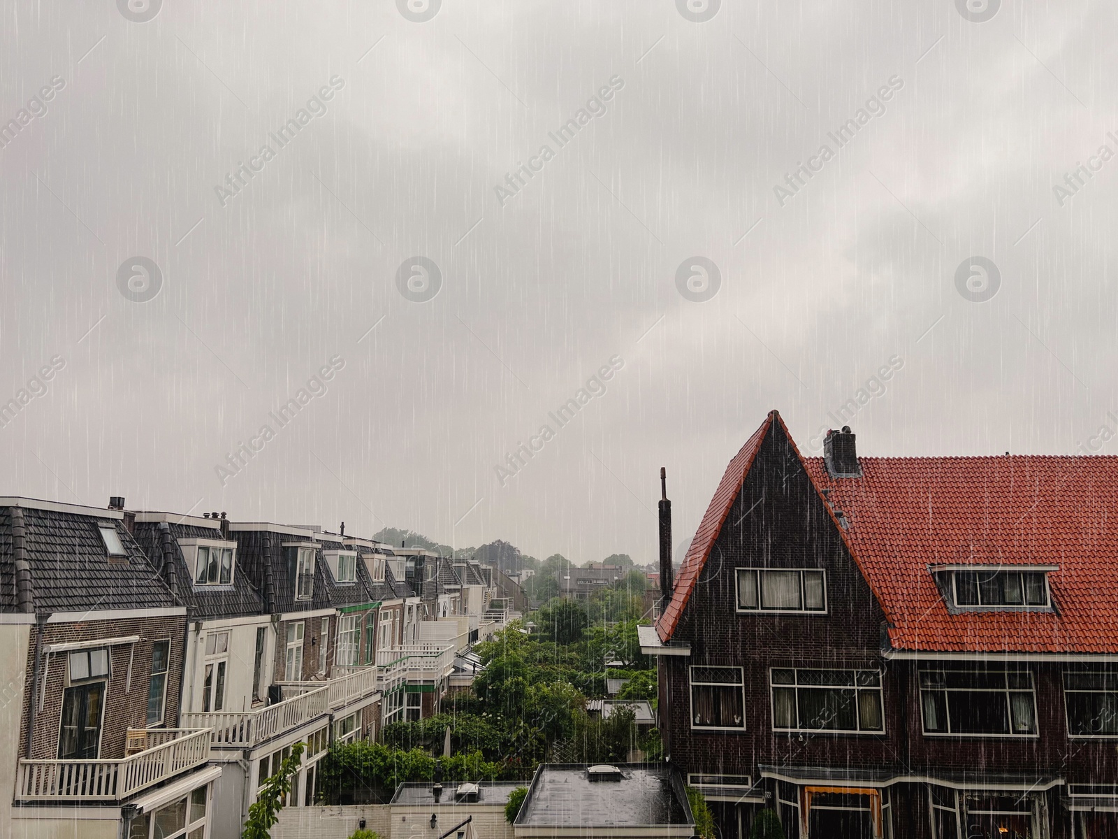 Photo of Picturesque view of city street with beautiful buildings on rainy day