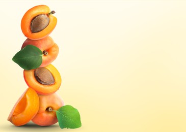 Image of Stack of fresh ripe apricots on pale yellow gradient background. Space for text