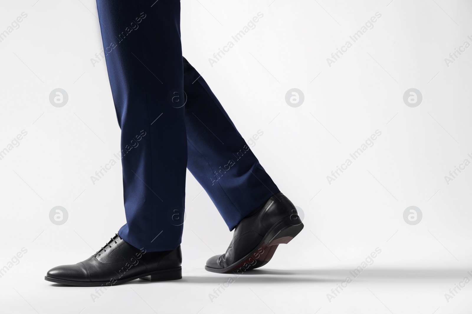 Photo of Businessman in leather shoes on white background, closeup