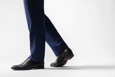 Businessman in leather shoes on white background, closeup