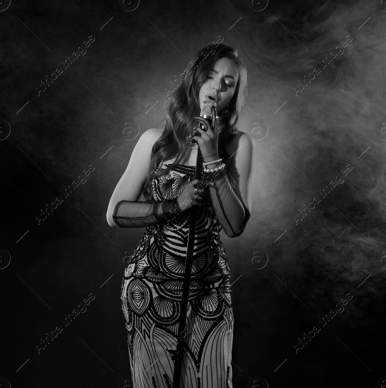 Image of Beautiful singer with microphone, black and white effect