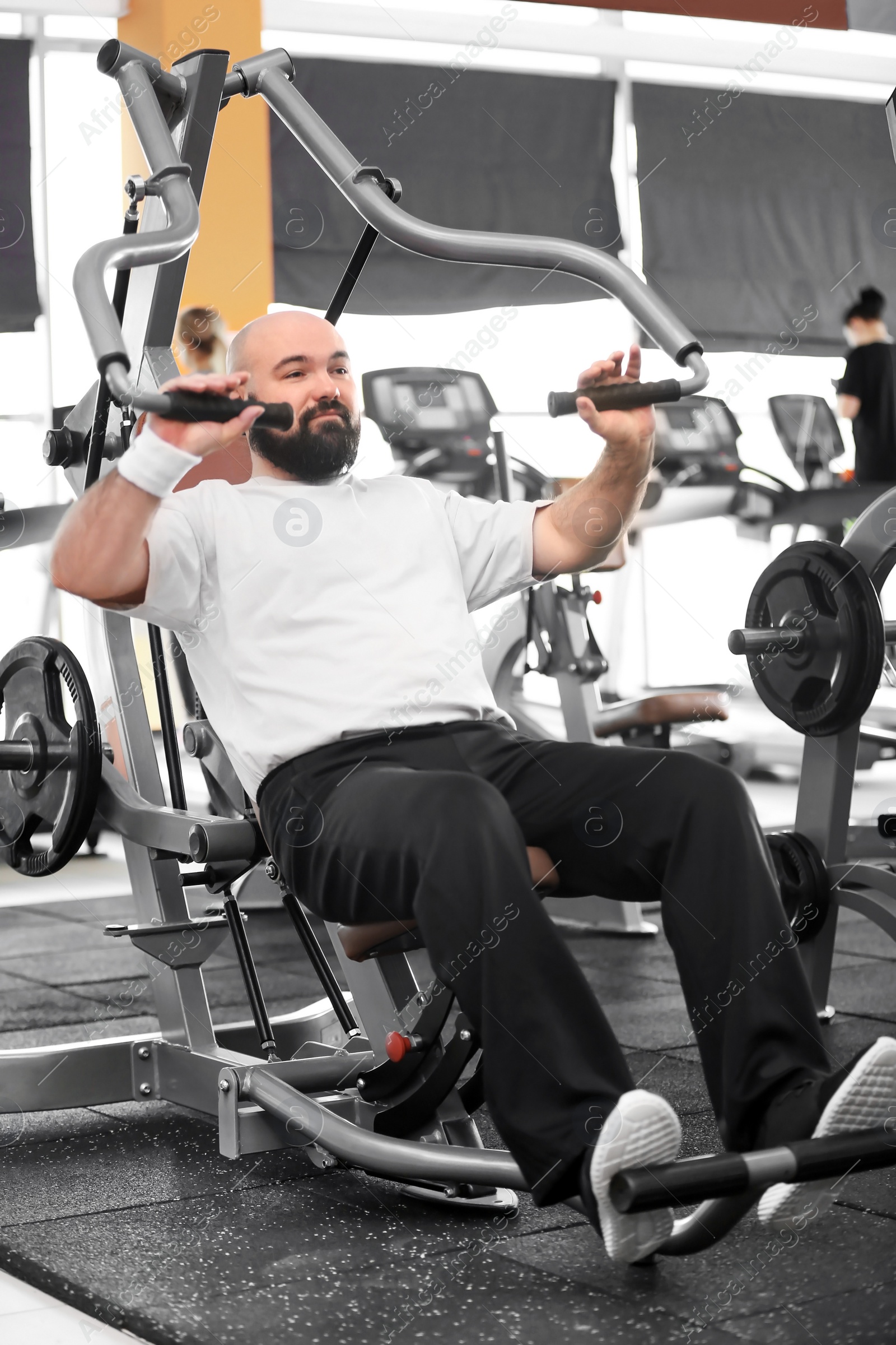 Photo of Overweight man training in gym