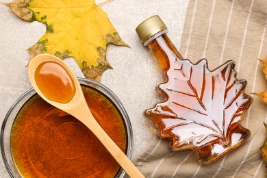 Photo of Flat lay composition with tasty maple syrup and dry leaves on light grey table