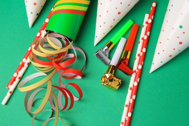 Photo of Many different party items on green background, flat lay