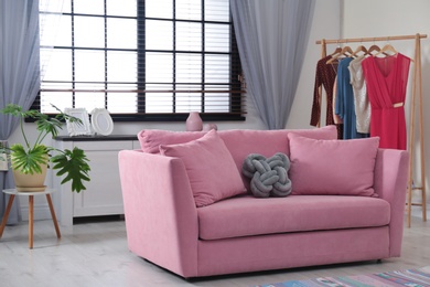 Photo of Comfortable sofa near window in stylish living room interior