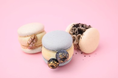 Photo of Delicious sweet macarons on pink background, closeup