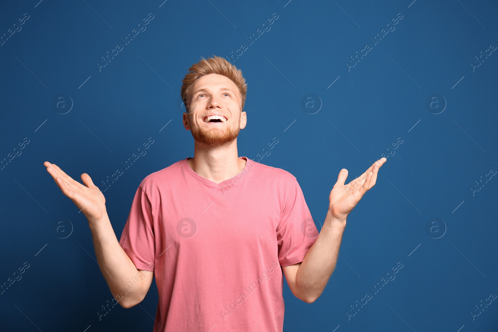 Photo of Portrait of happy young man on blue background