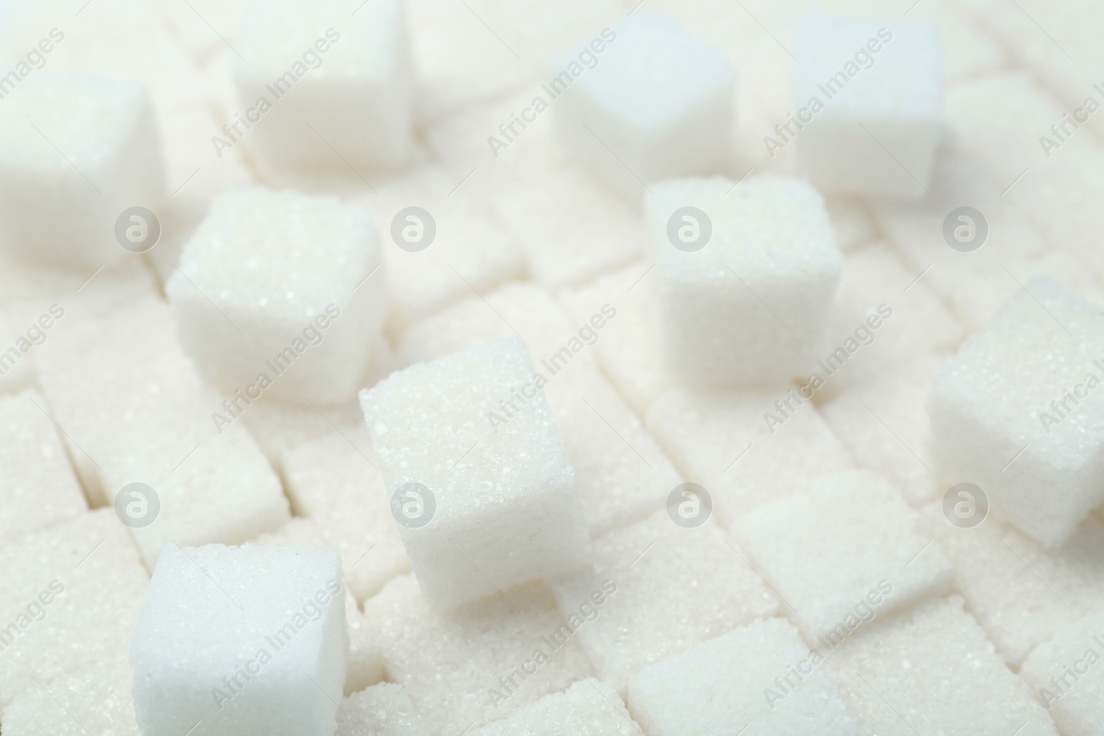 Photo of White sugar cubes as background, closeup view