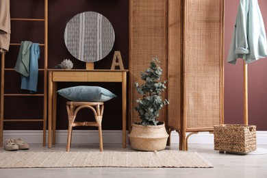 Stylish furniture, beautiful eucalyptus and decorative elements in room. Interior design