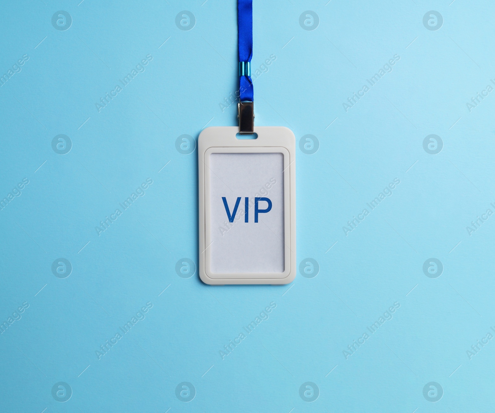 Photo of Plastic vip badge on light blue background, top view