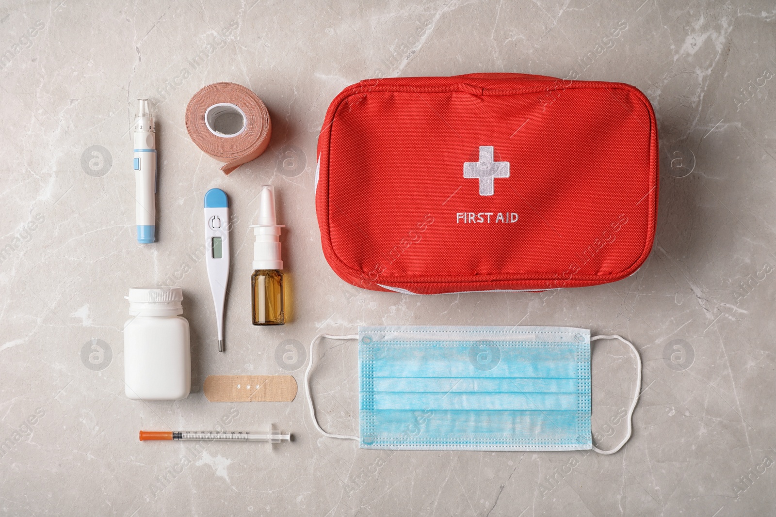 Photo of Flat lay composition with first aid kit on gray background