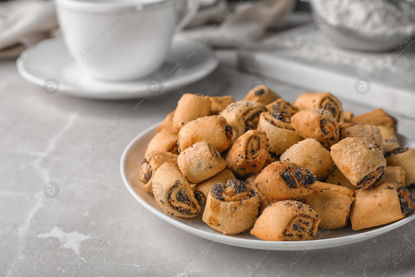 Photo of Tasty sweet cookies with poppy seeds on gray table