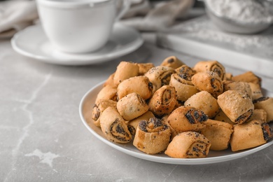 Photo of Tasty sweet cookies with poppy seeds on gray table