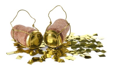 Photo of Corks of sparkling wine with muselet caps and shiny golden confetti on white background