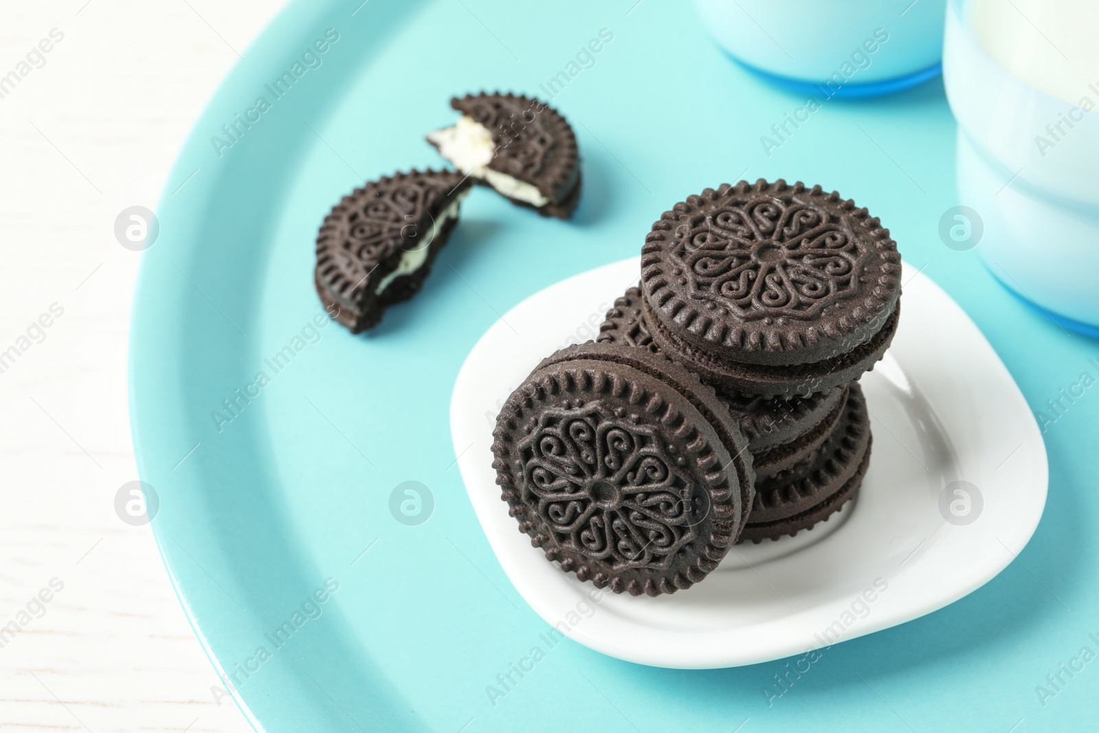 Photo of Tasty chocolate cookies with cream on tray