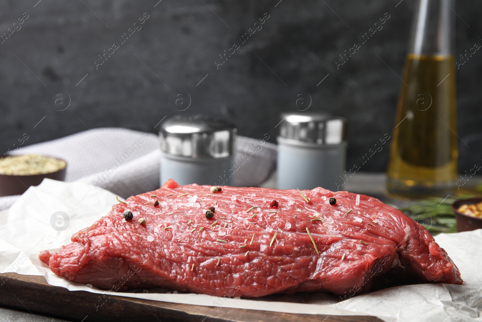 Photo of Fresh raw beef cut with spices on table, closeup