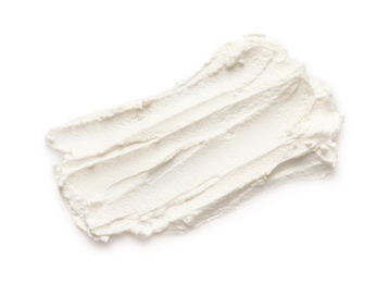 Photo of Smear of tasty cream cheese on white background, top view