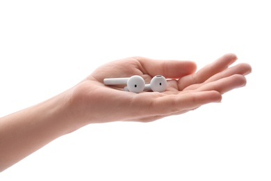 Photo of Woman holding modern wireless earphones on white background, closeup