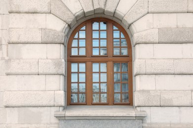 Photo of View of beautiful arched window in building outdoors