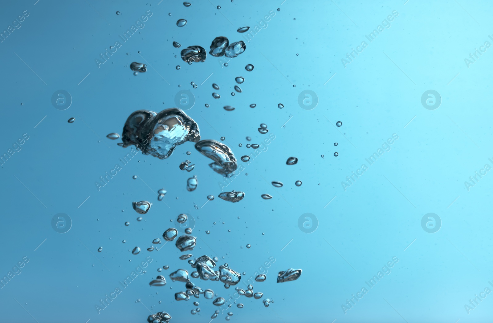 Photo of Air bubbles in water on blue background