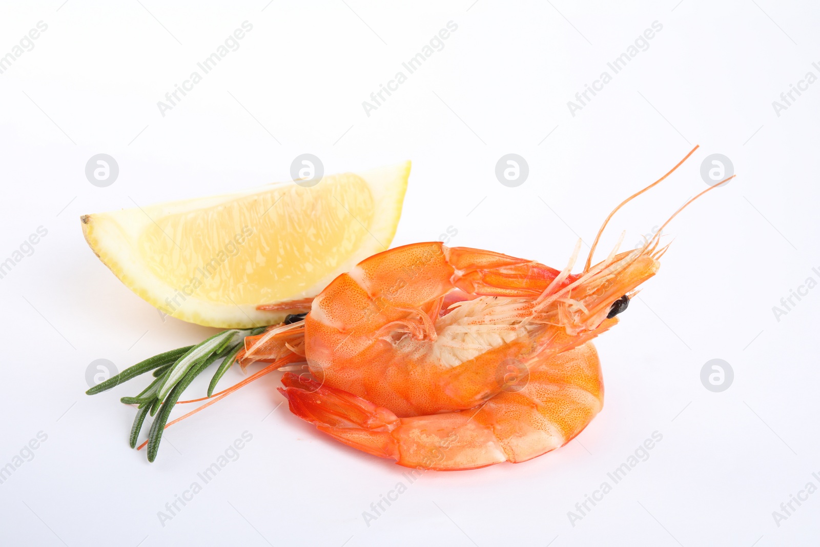 Photo of Delicious cooked shrimps, lemon and rosemary isolated on white