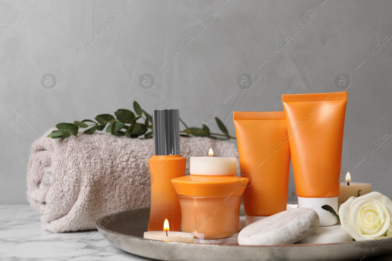 Photo of Composition with cosmetic products on white marble table