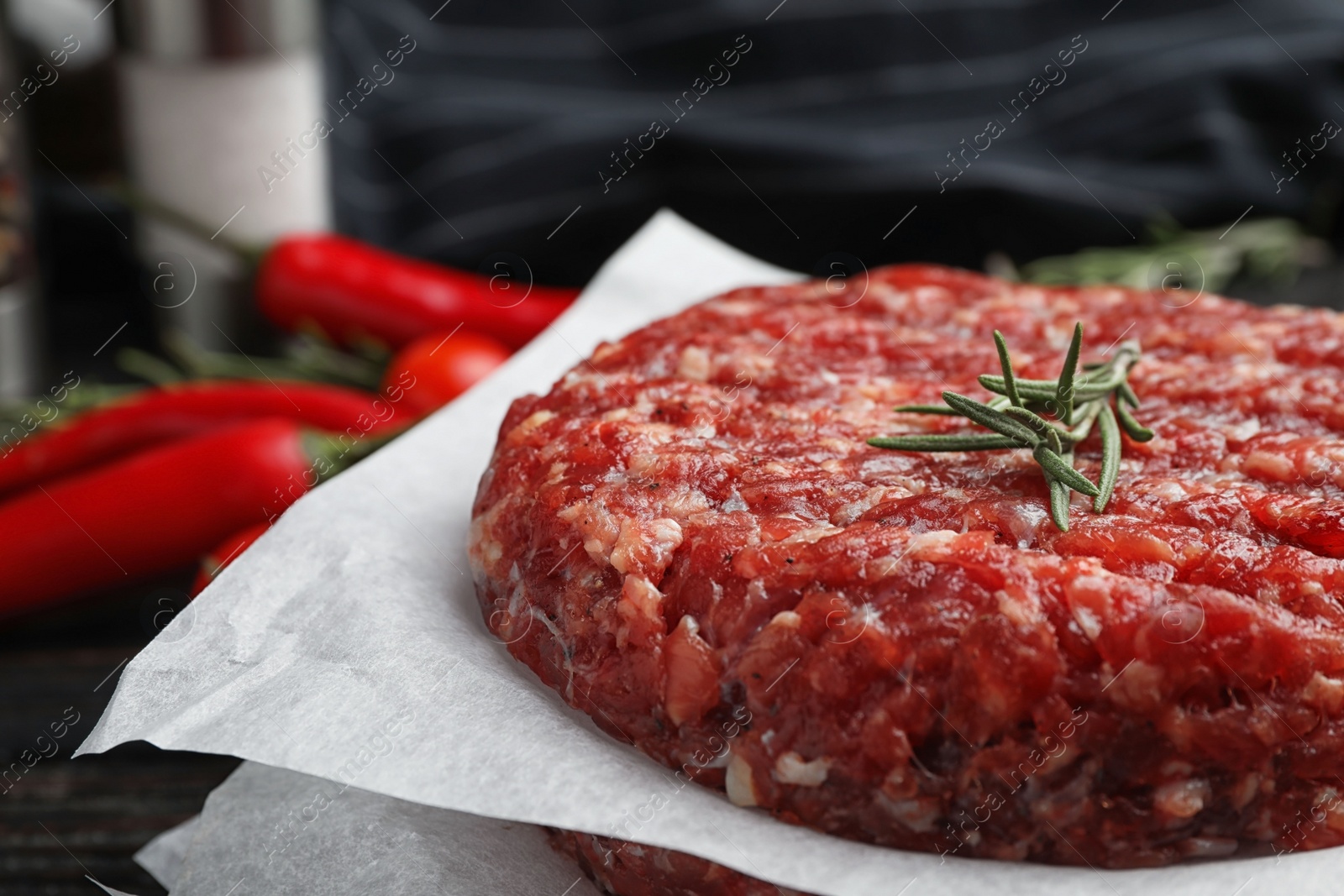 Photo of Raw meat cutlets for burger on table, closeup