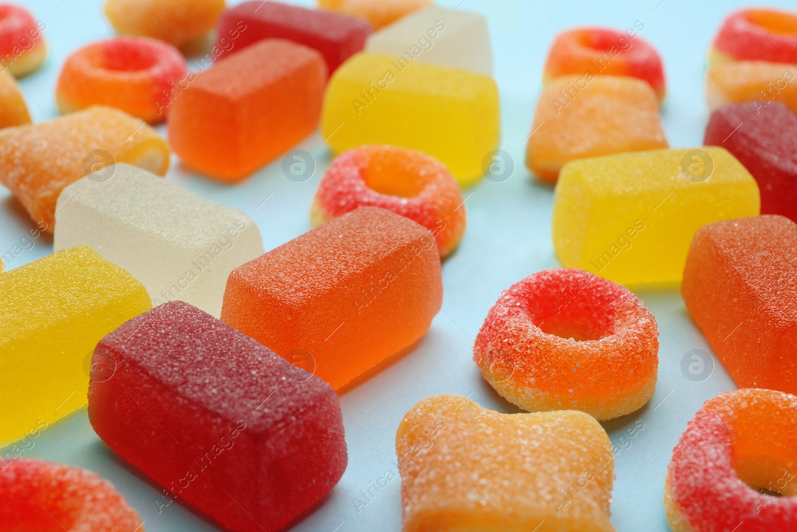 Photo of Different tasty jelly candies on color background