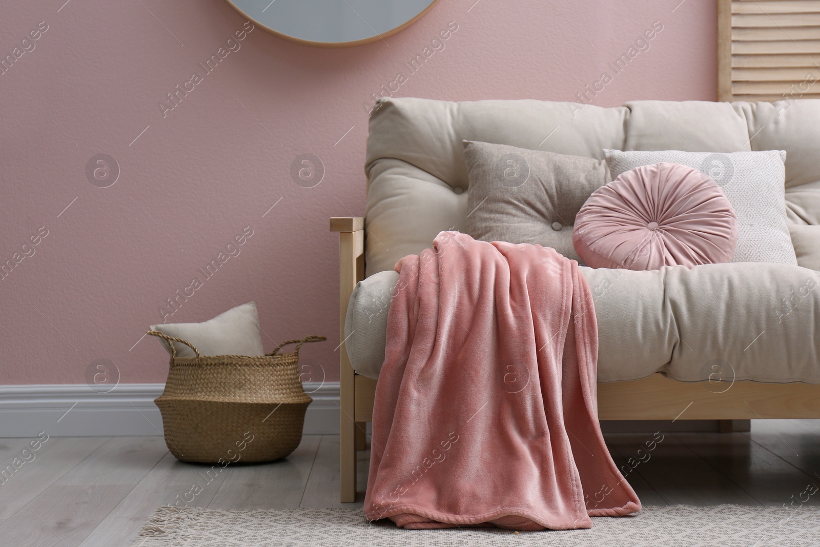 Photo of Modern living room interior with comfortable sofa and pink blanket