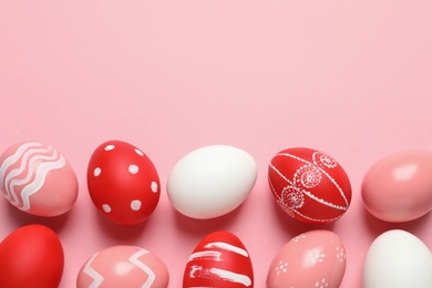 Photo of Flat lay composition with painted Easter eggs on color background, space for text