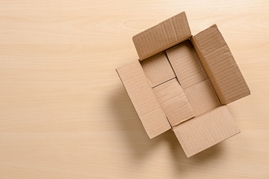 Photo of Cardboard box on wooden background