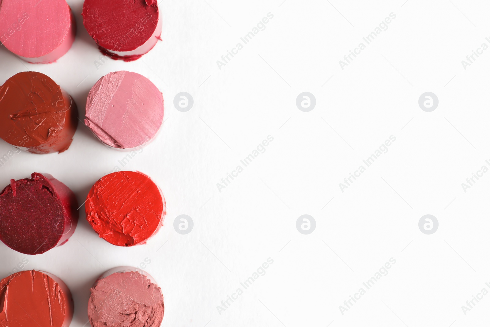 Photo of Different lipstick swatches on white background, top view