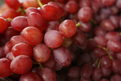 Photo of Fresh ripe juicy red grapes as background, closeup view