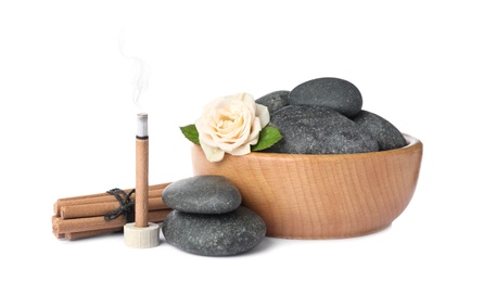 Photo of Composition with smoldering incense stick, rose and spa stones on white background