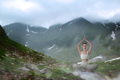 Woman meditating in mountains, space for text