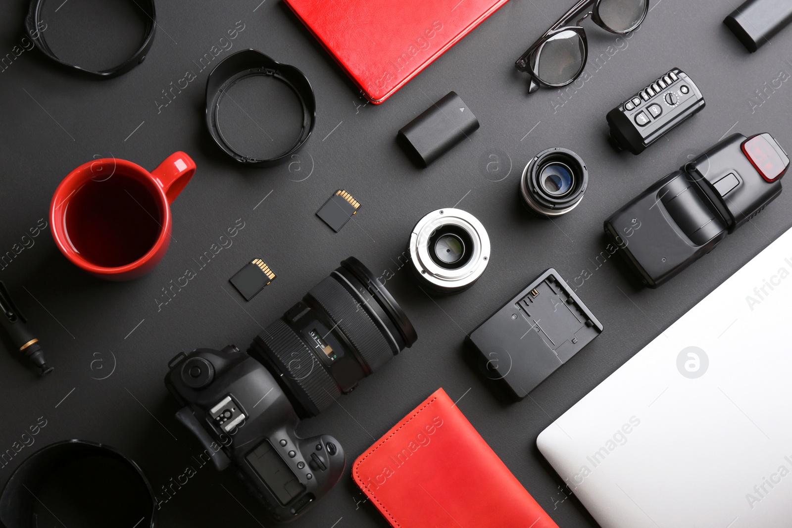 Photo of Flat lay composition with professional photographer equipment on dark background