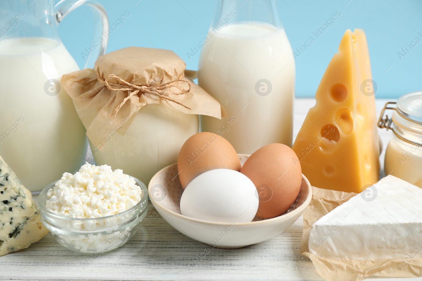 Photo of Different dairy products on white table, closeup