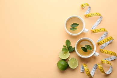 Flat lay composition with cups of diet herbal tea and measuring tape on orange background, space for text