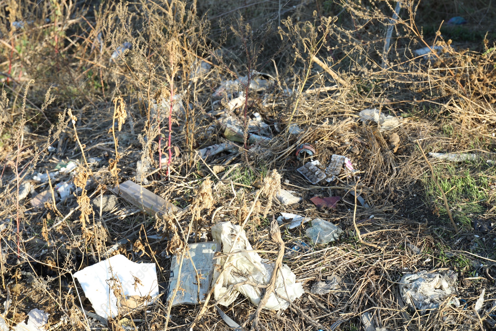 Photo of Different plastic garbage outdoors. Environmental pollution concept