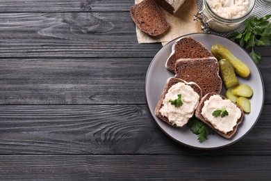 Photo of Delicious sandwiches with lard spread on black wooden table, flat lay. Space for text